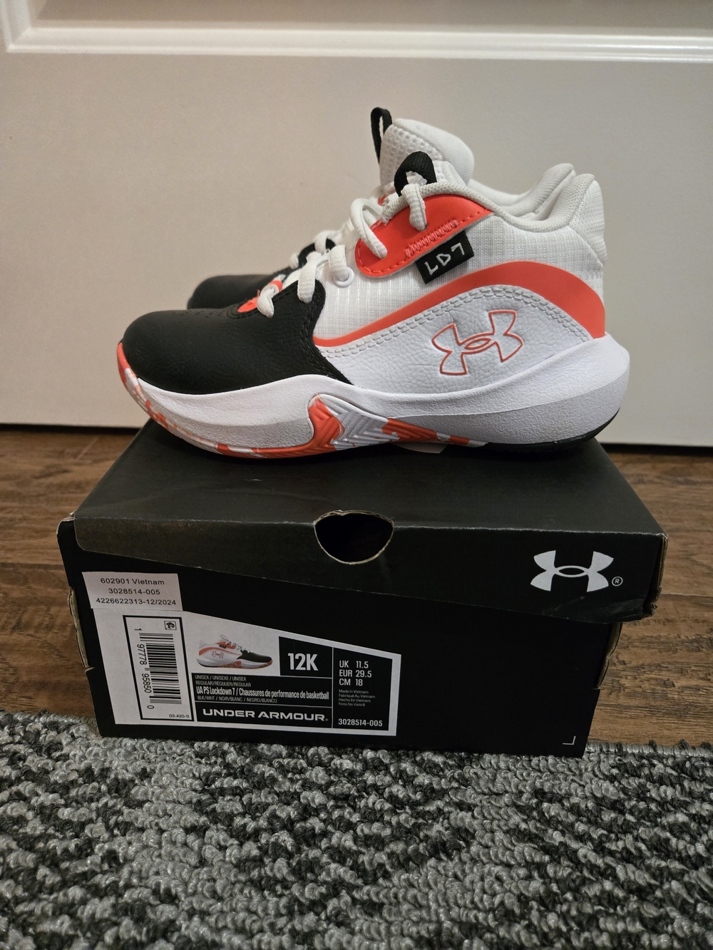 Under Armour Kids' White and Black Basketball Shoes with Orange Accents